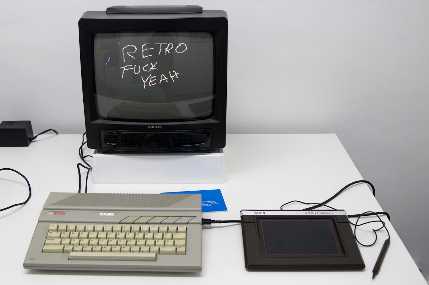 A black CRT beside a white keyboard