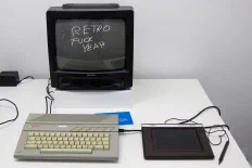 A black CRT beside a white keyboard