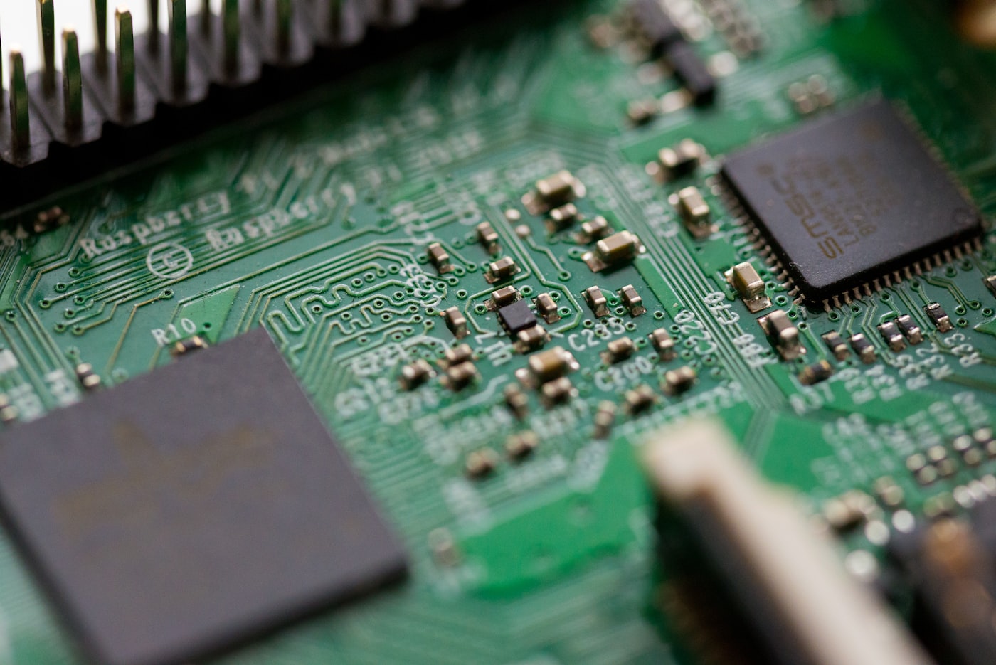 A green motherboard in tilt-shift focus